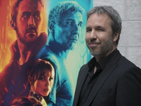 Denis Villeneuve is seen in front of a poster for his film Blade Runner 2049 in Montreal in September 2017.
