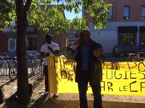 Members of the Montreal Guinean community participate in a protest rally outside Mont-Royal métro on Sunday, Oct. 1.