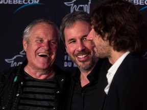 Quebec director Denis Villeneuve, centre, with festival founder Claude Chamberlan, left, and Nicolas Girard Deltruc, festival executive director on the red carpet at Place des Arts on Oct. 4, for the opening of the Festival du nouveau cinéma.