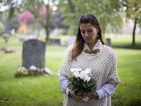 Annick Robinson visits the grave where her son Jacob is buried on Mount Royal Cemetery, in Montreal, October 7, 2017.