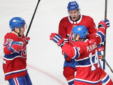 Montreal Canadiens' Tomas Plekanec (14) celebrates his goal with teammates Artturi Lehkonen (62) and Charles Hudon (54) during first-period action  in Montreal on Tuesday October 10, 2017.