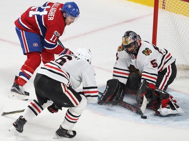 Montreal Canadiens' Brendan Gallagher (11) comes in close on Chicago Blackhawks goalie Corey Crawford with Michal Kempny (6) coming in on play, during second period NHL action in Montreal on Tuesday October 10, 2017.
