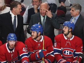 Canadiens coach Claude Julien, centre, with Kirk Muller, left, and Jean Jacques Daigneault, during the last few minutes of play in third-period action in Montreal Tuesday night.