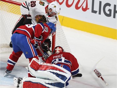 Montreal Canadiens goalie Carey Price stops puck on Chicago Blackhawks' Brandon Saad (20), while Victor Mete (53) comes in on the play, during first-period NHL action in Montreal on Tuesday October 10, 2017.