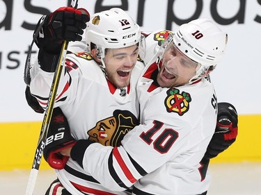 Chicago Blackhawks' Alex DeBrincat (12) celebrates goal with Patrick Sharp (10), during first-period NHL action in Montreal on Tuesday October 10, 2017.