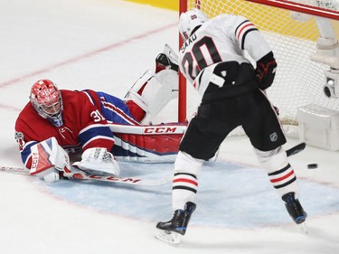 Montreal Canadiens goalie Carey Price goes to the ice as he tries to stop a goal by Chicago Blackhawks' Brandon Saad, during first-period NHL action in Montreal on Tuesday October 10, 2017.