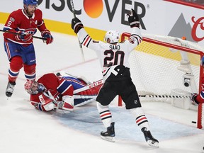 Blackhawks' Brandon Saad celebrates goal on Canadiens goalie Carey Price, while Shea Weber looks on during first-period action in Montreal on Tuesday.