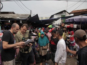 Producer Nabil Mehchi, left, director Van Royko and artist Ari Bayuaji on the scene in Jakarta for the CBC series Interrupt This Program.