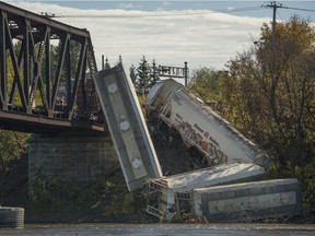 Eight railcars sit on the river bank and in the water October 13, 2017. The cars went off the tracks and half of them plunged into the Mille Iles river at 9:30 p.m. near Sophie-Masson Bridge between Laval and Terrebonne north of Montreal, Late Thursday night.