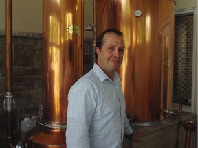 Domaine Lafrance owner Éric Lafrance in front of his still, which makes the base alcohol for Lafrance's Gin "Dandy."