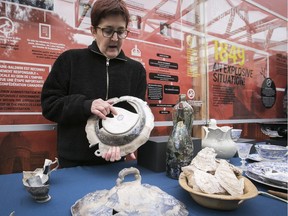 Archeologist Louise Pothier is seen with some of the artifacts unearthed during the summer on the site of the Parliament of the United Province of Canada, in Old Montreal on Tuesday Oct. 17, 2017.