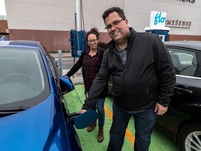 Eric Besner and his wife France Therrien charge up their new Chevy Volt at a FLO station at Fairview Pointe-Claire shopping centre.