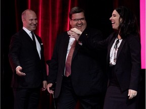 Michel Leblanc, left, president and CEO of the Montreal Board of Trade greets Denis Coderre and Valérie Plante on the stage as they prepare to take part in the French language debate Thursday night.