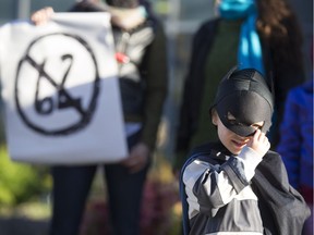 Three-and-a-half-year-old Malik Seligman participates in a demonstration against Bill 62 on the No. 80 bus route at Parc métro station in Montreal, Oct. 20, 2017.