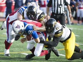 Montreal Alouettes quarterback Matthew Shiltz s sacked by Hamilton Tiger-Cats' Simoni Lawrence (21) and teammate Adrian Tracy (5) during second-half action in Montreal on Sunday, Oct. 22, 2017.