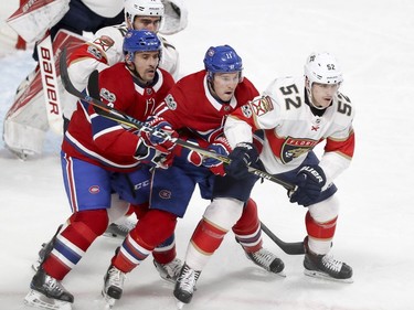 Montreal Canadiens Tomas Plekanec and Brendan Gallagher are flanked by Florida Panthers Ian McCoshen, left rear, and Mackenzie Weegar, right, in front of the Panthers net during first period of National Hockey League game in Montreal Tuesday October 24, 2017.