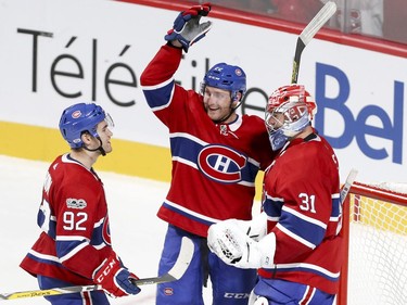 Montreal Canadiens Jonathan Drouin, left, and Karl Alzner celebrate their team's 5-1 victory over the Florida Panthers with goalie Carey Price after National Hockey League game in Montreal Tuesday October 24, 2017.