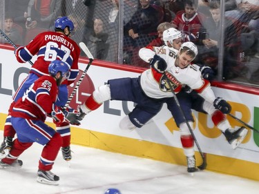 Montreal Canadiens Max Pacioretty sends Florida Panthers Evgenii Dadanov, rear, and Aleksander Barkov into the boards as Habs defenceman Victor Mete follows the puck during first period of National Hockey League game in Montreal Tuesday October 24, 2017.