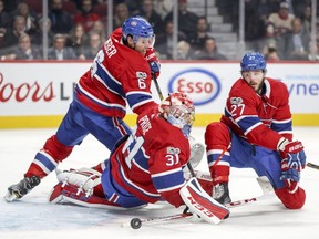 Canadiens' Shea Weber (6), Carey Price (31) and Alex Galchenyuk scramble to protect the net during second period Thursday night at the Bell Centre.