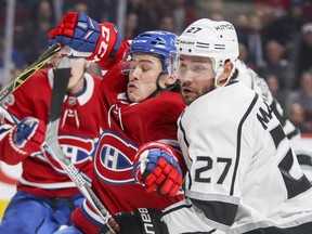 Montreal Canadiens Charles Hudon fight through check by Los Angeles Kings Alec Martinez during first period of National Hockey League game in Montreal Thursday October 26, 2017.