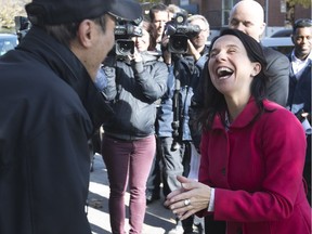 Valérie Plante, right, shares a laugh with Bounnhou Sananikone, as she visit a housing co-op in Côte-des- Neiges on Friday, Oct. 27, 2017.