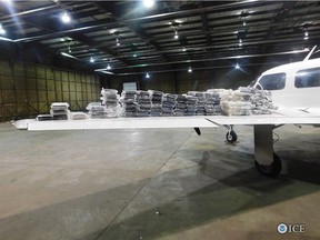 A photo released by U.S. Immigration and Customs Enforcement shows a Piper Navajo airplane with 132 bundles of cocaine seized at KUNI Ohio University Airport in March 2017.
