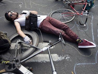 Cycling advocates held a "die-in" to call for greater road safety on Oct. 28, 2017 at Parc and St-Viateur, near a ghost bike that was erected four years ago to mark a cyclist's death. (Christinne Muschi / MONTREAL GAZETTE)