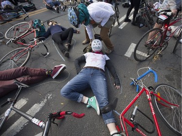 "Die-in" demonstrations, like the one in Montreal Oct. 28, 2017 at Parc and St-Viateur, have been used around to world to draw attention to car violence. (Christinne Muschi / MONTREAL GAZETTE)