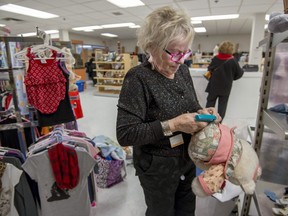 Volunteer Irene Crozier puts price tags on articles at the new NOVA thrift shop in the former RBC spot at Plaza Pointe-Claire.