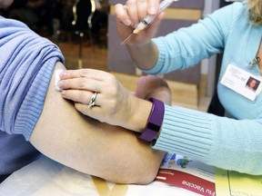 A nurse administers a flu shot.