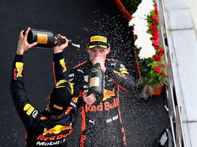 Race winner Max Verstappen of the Netherlands and Red Bull Racing celebrates with third-place finisher Daniel Ricciardo of Australia and Red Bull Racing on the podium during the Malaysia Formula One Grand Prix at Sepang Circuit on October 1, 2017 in Kuala Lumpur, Malaysia.