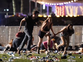 People run from the Route 91 Harvest country music festival after gunfire was hear Oct. 1, 2017 in Las Vegas, Nev.