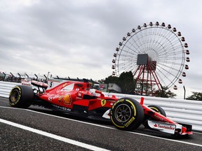 Sebastian Vettel steers his Ferrari during Friday practice for the Japanese Grand Prix. He posted the fastest lap of time of the day.