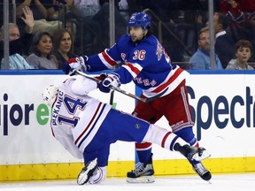 Rangers' Mats Zuccarello hits Canadiens' Tomas Plekanec during the first period at Madison Square Garden on Sunday, Oct. 8, 2017, in New York City.