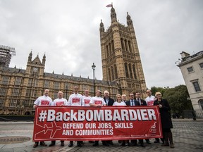 Workers from the Bombardier factory in Belfast and supporters, hold a banner to highlight their situation as they meet UK MPs Oct. 11, 2017 in London, England. The group is to meet Business Secretary Greg Clark to discuss the implications of a trade dispute with rival firm Boeing over alleged below-cost selling of its C-Series jet.