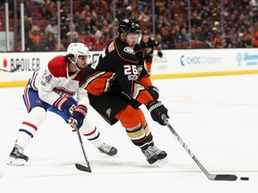 Canadiens' Phillip Danault chases Ducks' Brandon Montour during game Friday night in Anaheim, Calif.