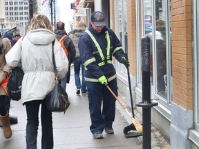 Michel Beauchemin cleans the sidewalks on Ste-Catherine W. on Dec. 23, 2016.