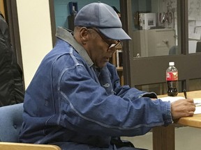 Former football legend O.J. Simpson signs documents at the Lovelock Correctional Center, Saturday, Sept. 30, 2017, in Lovelock, Nev. Simpson was released from the Lovelock Correctional Center in northern Nevada early Sunday, Oct. 1, 2017.