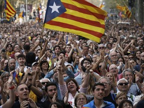 Protesters reacts as they watch the parliament session on a huge screen during a rally outside the Catalan Parliament, in Barcelona, Spain, Friday, Oct. 27, 2017. Catalonias' regional Parliament passed a motion Friday to establish an independent Catalan Republic(