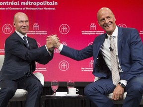 Bombardier President and CEO Alain Bellemare, left, and Airbus CEO Tom Enders lock hands during a meeting in Montreal on Oct. 20.