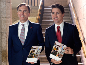 Finance Minister Bill Morneau and Prime Minister Justin Trudeau proudly display copies of the federal budget on March 22, 2017.