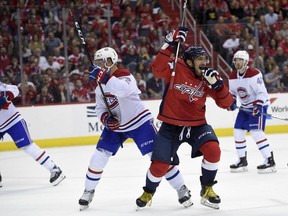 Capitals' Alex Ovechkin (8) celebrates his goal next to Canadiens defenceman Karl Alzner (22) during the first period of an NHL hockey game on Saturday, Oct. 7, 2017, in Washington. This was Ovechkin's third goal of the period and the game.