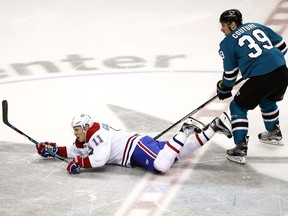 Montreal Canadiens right wing Brendan Gallagher (11) is tripped from behind by San Jose Sharks center Logan Couture (39) during the third period of an NHL hockey game, Tuesday, Oct. 17, 2017, in San Jose, Calif. San Jose won 5-2.