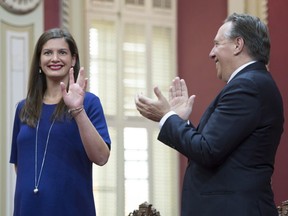 Coalition Avenir Quebec newly-elected member Geneviève Guilbault, left, is applauded by Coalition Avenir Quebec Leader François Legault before being sworn in as a Member of the National Assembly, Monday, October 16, 2017 at the legislature in Quebec City.