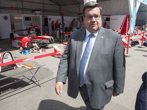 Montreal Mayor Denis Coderre walks through the paddock at the Montreal Formula ePrix electric car race, in Montreal in July 2017.