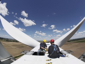 Jeremy Chenoweth, left, and Benjamin Werkowski of edp Renewables work atop one of the 52 windmills the company operates in Ohio.