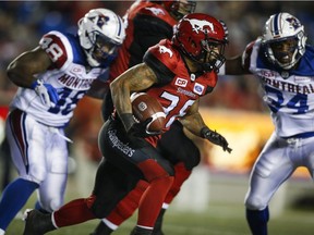 Alouettes linebacker Reggie Northrup (48), making his CFL debut, and linebacker Kyries Hebert (34) converge on Calgary Stampeders running back Terry Williams in Calgary on Friday, Sept. 29, 2017.