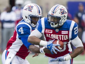 Alouettes running-back Tyrell Sutton takes a handoff from quarterback Darian Durant last season.