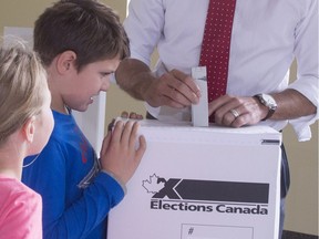 Justin Trudeau drops his vote in the ballot box as his daughter Ella-Grace and son Xavier look on Monday, October 19, 2015 in Montreal. Voting is learned behaviour, so get out to vote in the Nov. 5 municipal elections, and bring your kids with you; active, engaged citizens are the true guarantors of Canada's democracy, Celine Cooper writes.