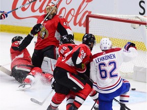 Montreal Canadiens left wing Artturi Lehkonen (62) scores as Ottawa Senators right wing Alexandre Burrows (14) gets tangled up with goalie Craig Anderson (41) and defenceman Erik Karlsson (65) and defenceman Johnny Oduya (29) defend during first period NHL hockey action in Ottawa on Monday Oct. 30, 2017.